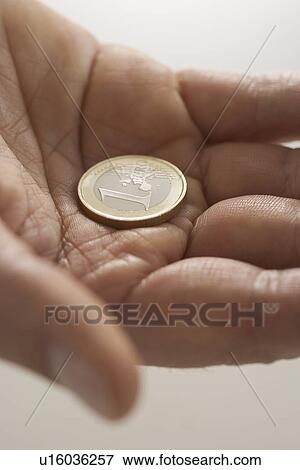 Closeup of Euro coin in palm View Large Photo Image Stock Photo - Closeup of Euro coin in palm. Fotosearch