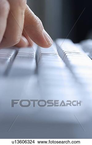 Closeup of finger and blurred keyboard View Large Photo Image Picture - Closeup of finger and blurred keyboard. Fotosearch