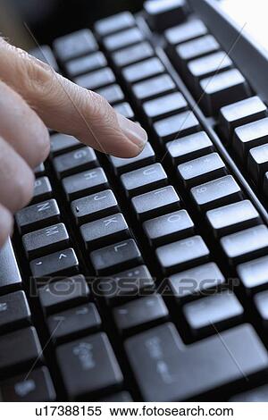 Closeup of finger and computer keyboard View Large Photo Image Stock Photography - Closeup of finger and computer keyboard. Fotosearch