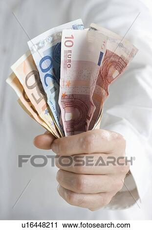 Closeup of fistful of European money View Large Photo Image Stock Image - Closeup of fistful of European money. Fotosearch