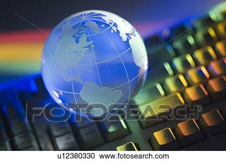 Stock Image - Closeup of globe and keyboard. Fotosearch