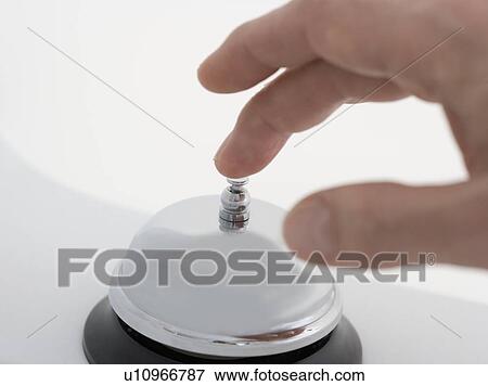 Closeup of hand ringing desk bell View Large Photo Image Stock Photo - Closeup of hand ringing desk bell. Fotosearch