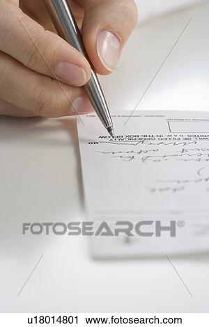 Stock Image - Closeup of hand writing prescription. Fotosearch