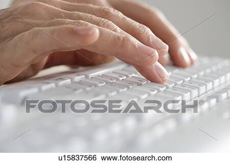 Stock Photograph - Closeup of hands on computer keyboard. Fotosearch