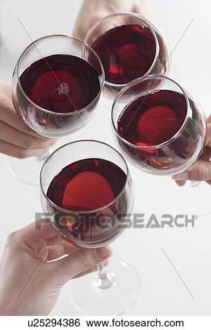Stock Photograph - Closeup of hands toasting with wine. Fotosearch