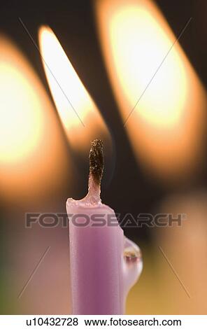 Stock Photo - Closeup of lit candles. Fotosearch