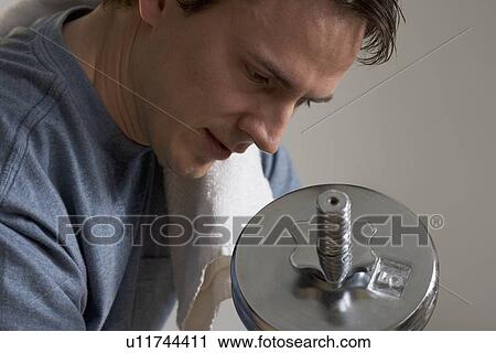 Stock Image - Closeup of man lifting weights. Fotosearch
