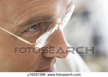 Closeup of man wearing glasses View Large Photo Image Stock Photo - Closeup of man wearing glasses. Fotosearch