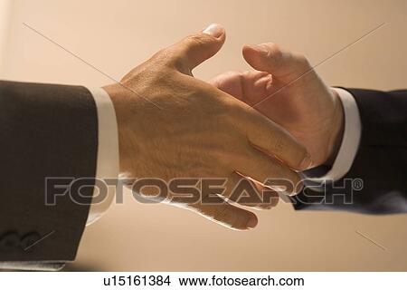 Picture - Closeup of men shaking hands. Fotosearch