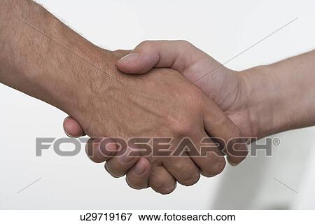 Stock Photo - Closeup of men shaking hands. Fotosearch
