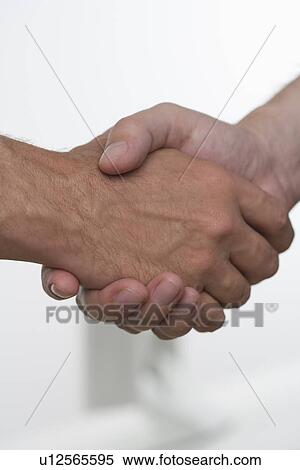 Stock Photography - Closeup of men shaking hands. Fotosearch