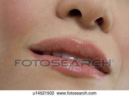Stock Image - Closeup of parted female lips. Fotosearch