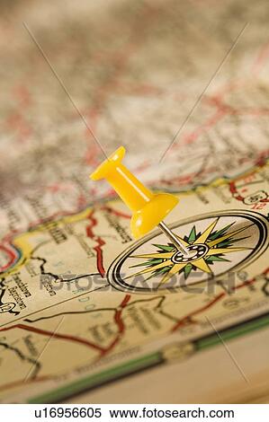 Stock Photography - Closeup of push pin and map. Fotosearch