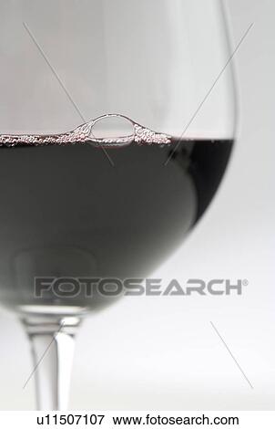 Stock Photo - Closeup of red wine with bubbles. Fotosearch