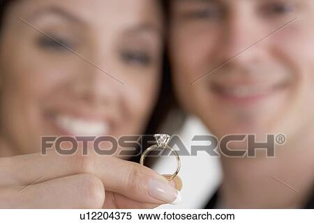Closeup of ring and admiring couple View Large Photo Image Stock Photography - Closeup of ring and admiring couple. Fotosearch