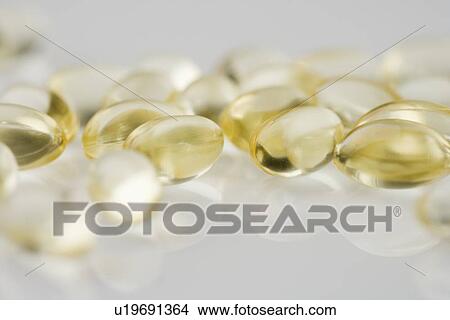 Closeup of several yellow gelcaps View Large Photo Image Picture - Closeup of several yellow gelcaps. Fotosearch