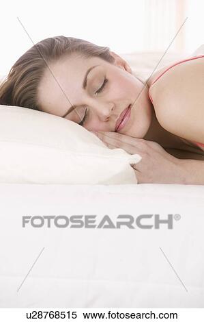 Stock Photography - Closeup of smiling woman sleeping. Fotosearch