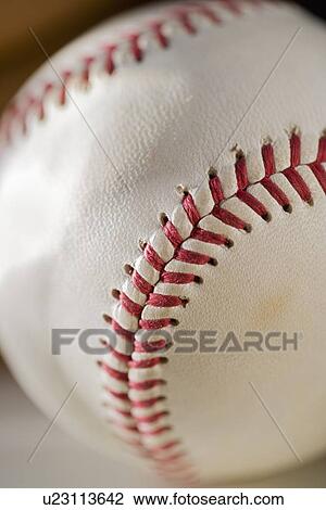 Stock Image - Closeup of stitching on a baseball. Fotosearch