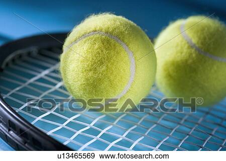 Closeup of tennis racquet and two balls View Large Photo Image Stock Photo - Closeup of tennis racquet and two balls. Fotosearch