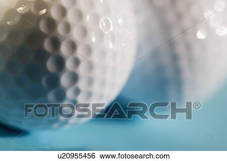 Stock Photograph - Closeup of two golf balls. Fotosearch
