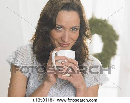 Closeup of woman sipping from a mug View Large Photo Image Stock Photo - Closeup of woman sipping from a mug. Fotosearch