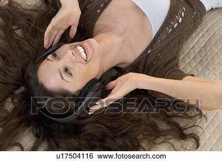 Stock Photograph - Closeup of woman with headphones on. Fotosearch