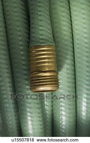 Stock Photo - Closeup of wound up garden hose. Fotosearch