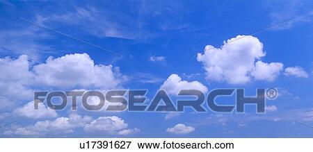 Stock Photo - Clouds against a blue sky. Fotosearch