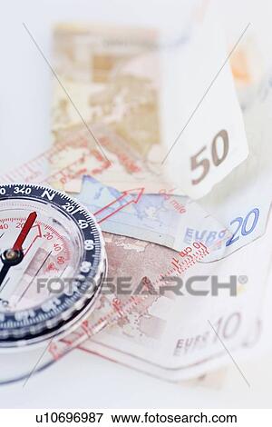Compass with money - high angle View Large Photo Image Stock Photo - Compass with money - high angle. Fotosearch
