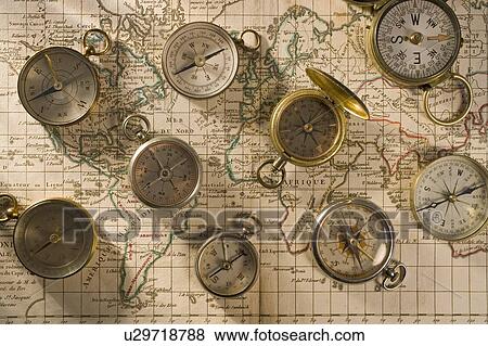 Stock Photo - Compasses on a map. Fotosearch