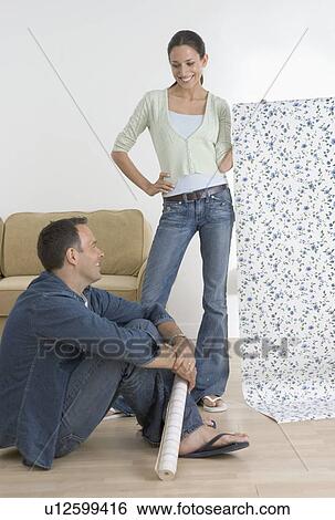 Stock Photograph - Couple decorating their home. Fotosearch