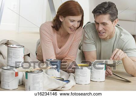 Stock Photograph - Couple discussing paint color choices. Fotosearch