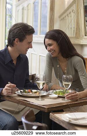 Stock Photo - Couple eating at restaurant. Fotosearch