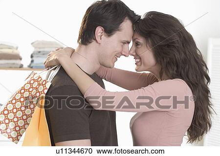 Couple embracing with foreheads touching View Large Photo Image Stock Image - Couple embracing with foreheads touching. Fotosearch