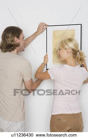 Couple hanging pictures View Large Photo Image Stock Image - Couple hanging pictures. Fotosearch