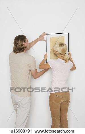 Couple hanging pictures View Large Photo Image Stock Image - Couple hanging pictures. Fotosearch