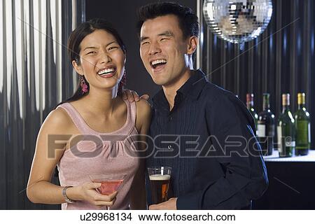 Couple having drinks in a bar View Large Photo Image Picture - Couple having drinks in a bar. Fotosearch