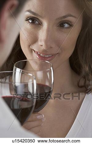 Stock Image - Couple holding wine glasses. Fotosearch