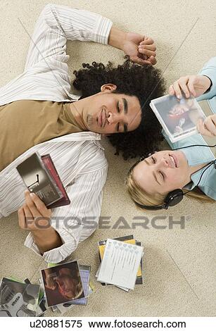 Couple listening to music View Large Photo Image Stock Photography - Couple listening to music. Fotosearch