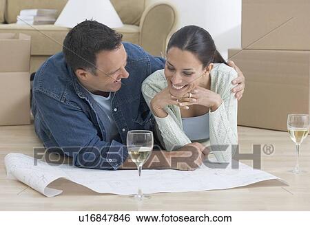 Stock Photograph - Couple looking at blueprints. Fotosearch