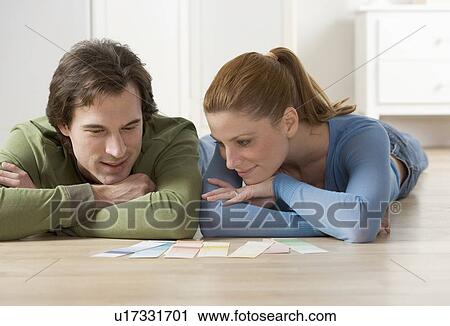 Stock Image - Couple picking out paint colors. Fotosearch