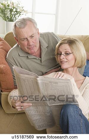 Couple relaxing at home View Large Photo Image Stock Photo - Couple relaxing at home. Fotosearch
