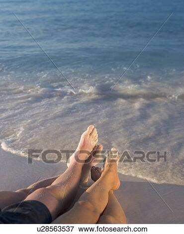 Couple relaxing on beach View Large Photo Image Stock Photo - Couple relaxing on beach. Fotosearch