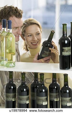 Picture - Couple selecting wine. Fotosearch