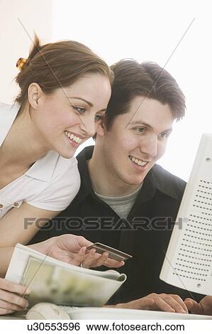 Stock Photograph - Couple shopping online. Fotosearch