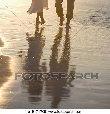 Stock Photo - Couple strolling the beach. Fotosearch