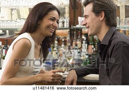 Couple talking at bar View Large Photo Image Stock Photograph - Couple talking at bar. Fotosearch