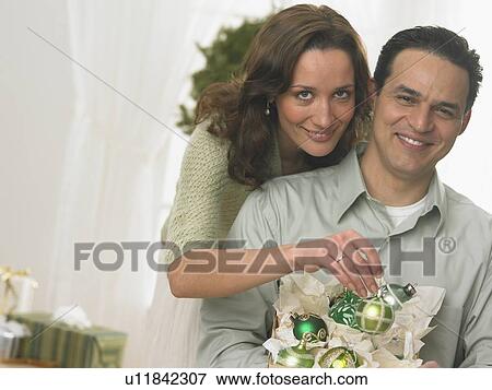 Stock Photo - Couple unpacking Christmas ornaments. Fotosearch