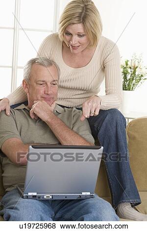 Stock Photo - Couple using laptop computer at home. Fotosearch