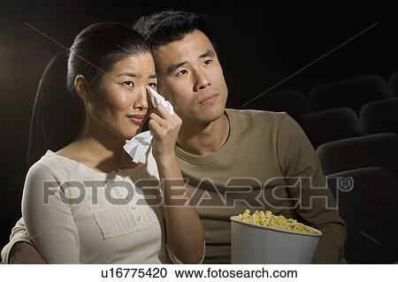 Couple watching a sad movie View Large Photo Image Stock Image - Couple watching a sad movie. Fotosearch